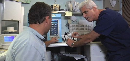 Dr. Mormino in his dental laboratory helping a patient